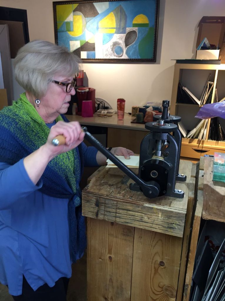 Using rolling mill to impart texture to metal for Rolling Textured Earring class as Gallery's Choice.