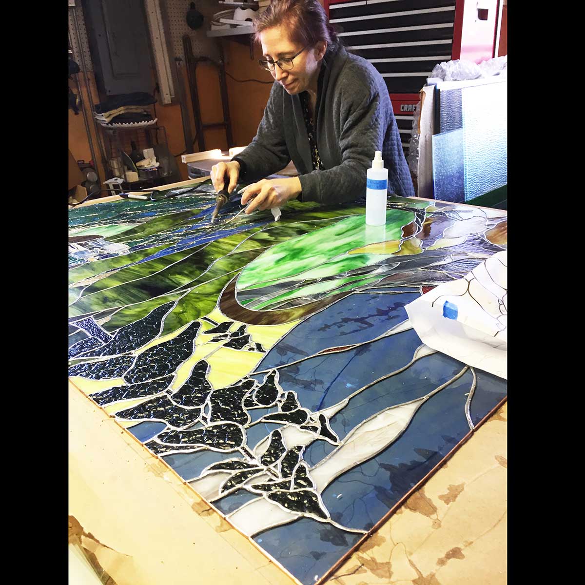 Crest Mountain custom stained glass from above in studio