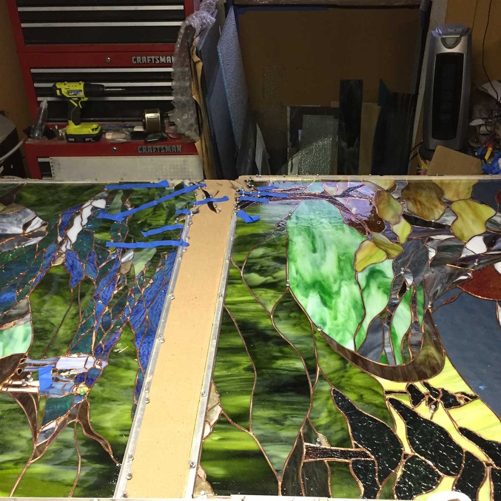 Two haves of large stained glass work coming together at Gallery's Choice studio